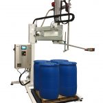 Bottom Up Net Weight Semi Automatic Liquid Filler for Drums and Totes. Painted with stainless steel parts for use with food products.